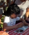 Joey Alexander, a 12-year old child prodigy and accomplished pianist, at autograph signing table, Newport Jazz Festival 2015